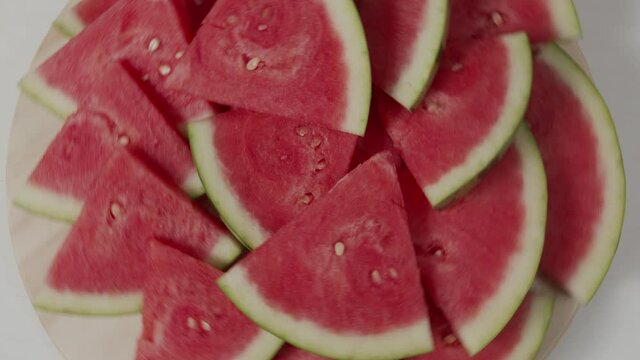 slices of watermelon rotate top view on a table