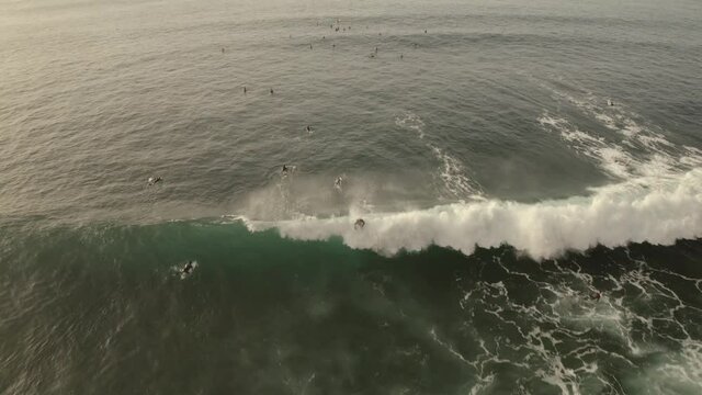  group of surfers ride on huge waves. Tenerife, Spain