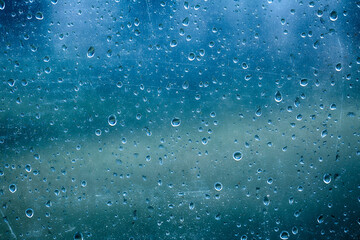 Naklejka na ściany i meble Beautiful rain drops on grunge glass blurry background.