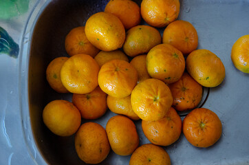 top view on a sink full of tangerines