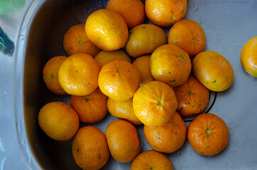 top view on a sink full of tangerines