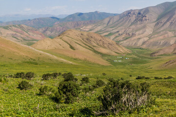 Obraz premium Green valley with yurt camps near Song Kul lake, Kyrgyzstan