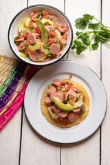Mexican sausage ceviche with avocado on white background