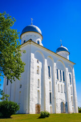 It's St. George's (Yuriev) Monastery, Russia's oldest monastery. It is part of the World Heritage Site named Historic Monuments of Novgorod and Surroundings.