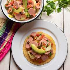 Mexican sausage ceviche with avocado on white background