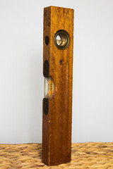 Wooden level tool antique vertical with blank background.