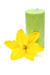 Obraz na płótnie Canvas Green candle with yellow flower lily isolated on a white background