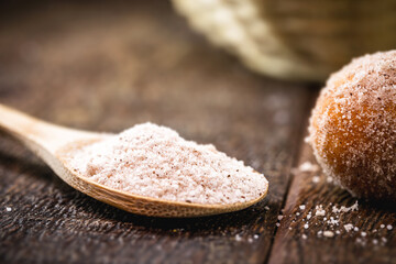 wooden spoon with refined sugar and powdered cinnamon. Typical ingredient of Brazilian cuisine.