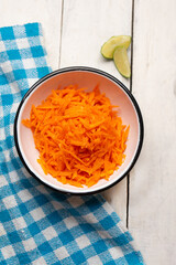 Grated carrot with lime and salt on white background