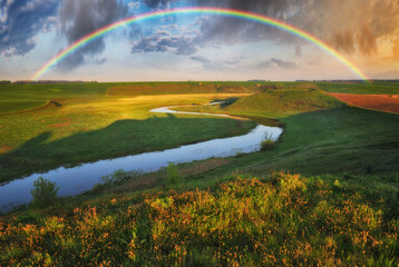 Naklejka premium Landscape with a Rainbow on the River in Spring