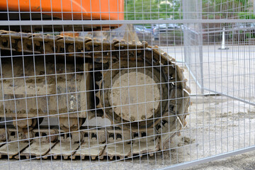 Buldozer tracks behind a fence in downtown construction site