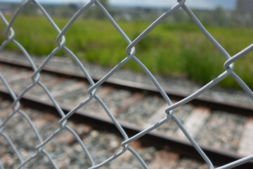 Chain Link Mesh Fence in front of Railway Track