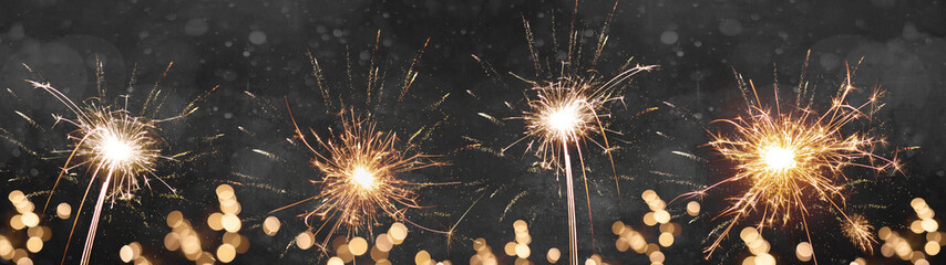 Festive celebration Silvester New Year background banner - Sparklers firework and bokeh lights...