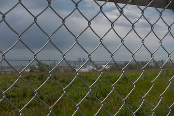 Chain Link Mesh Fence with calgary skyline in distance