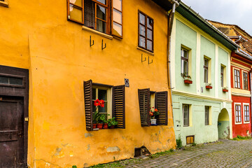 Fototapeta na wymiar Colourful houses of the historic centre of Sighisoara, Romania. UNESCO World Heritage