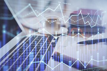 Double exposure of financial chart drawing and desktop with coffee and items on table background. Concept of forex market trading