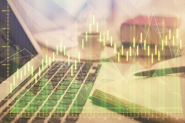 Double exposure of financial chart drawing and desktop with coffee and items on table background. Concept of forex market trading