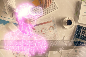 Double exposure of man's hands typing over computer keyboard and virtual reality hologram drawing. Top view. Technology concept. Future.