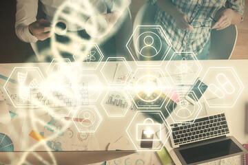 Double exposure of man and woman working together and DNA hologram drawing. Computer background....