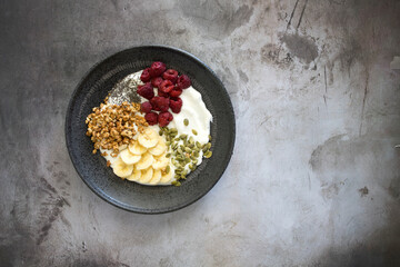 Yogurt with Raspberries, Bananas, Granola and Pumpkin Seeds