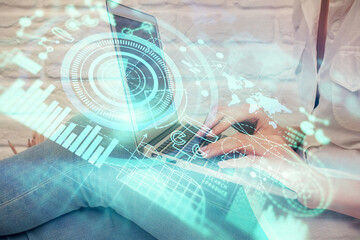 Double exposure of woman hands typing on computer and business theme hologram drawing. Success concept.