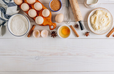 Fototapeta na wymiar Ingredients for baking and Breakfast with eggs, flour, sugar, milk and butter on a white wooden background. Delicious and healthy food. Flat lay.