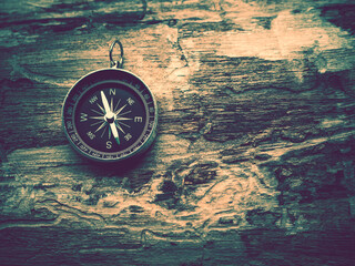 Antique golden compass on the wooden background in journey for direction, travel, guidance or...