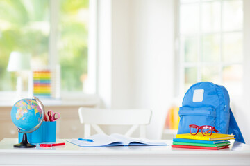 Back to school. Kids desk with books, globe.