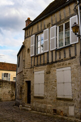 Fototapeta na wymiar Stone street in Senlis, Medieval town in the Oise department, France
