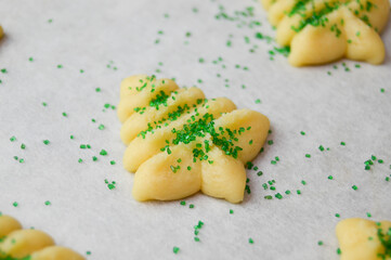 Christmas tree shaped spritz cookies on parchment paper