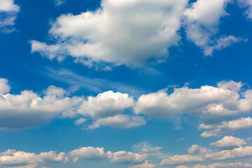 Gray and white clouds on blue sky background.
