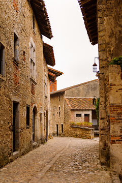Narrow street in  Perouges, France, a medieval walled town, a popular touristic attraction.