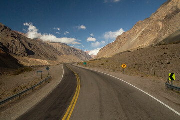 Travel. Rural highway. The curved asphalt road along the mountains and desert on the road to Aconcagua in Mendoza, Patagonia Argentina. 