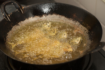 Fish being cooked in a pan