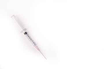 medical syringes and medical face mask,shot from top,spread over white surface