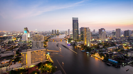 Fototapeta na wymiar Bangkok Transportation at Dusk with Modern Business Building along the river