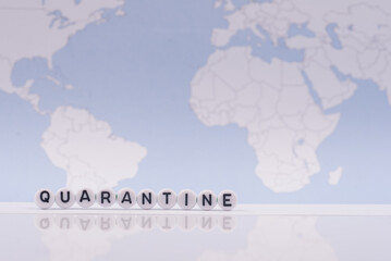 The word quarantine with world map in the background