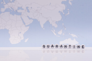 The word quarantine with world map in the background