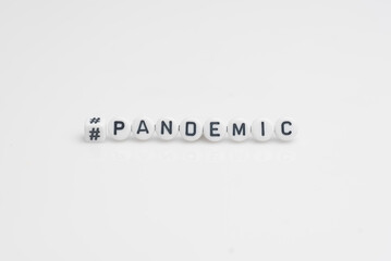 The word pandemic in small alphabetical beads, isolated over white