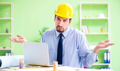 Young male architect working at the project