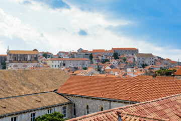 Fototapeta na wymiar It's View from the wall on the roof tops of the Old Town of Dubrovnik on a cloudy day, Croatia