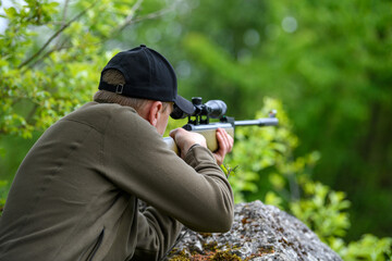 Male with a gun in hunting period