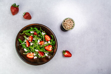Strawberry salad with arugula and cheese. Healthy food. banner menu recipe place for text, top view