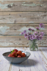 ripe, fresh strawberries in a gray plate