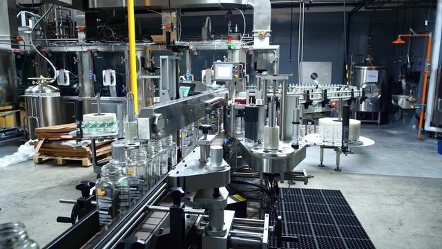 Juice bottling plant. Glass bottles on conveyor belt in beverage factory. Robotic automation line. packaging warehouse & processing facility.