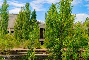 Abandoned Palace of Culture Energetic surrounded  by green trees in Pripyat, a ghost town in northern Ukraine, evacuated the day after the Chernobyl disaster on April 26, 1986