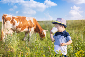 little boy drinking milk outdoors