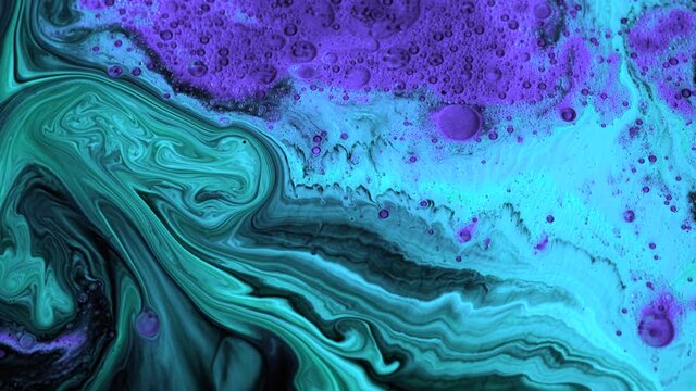 Slowly liquid texture of paint. Stock footage. Beautiful patterned streams of liquid paint move on black background. Artistic background with slowly changing pattern of colors