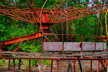 Fototapeta na wymiar Damaged carousel in the former amusement park in Pripyat, a ghost town in northern Ukraine, evacuated the day after the Chernobyl disaster on April 26, 1986