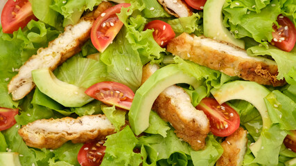 chicken salad with avocado, tomatoes, lettuce, sesame seeds. Healthy salad with chicken